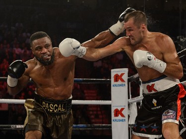 Jean Pascal of Laval throws a punch toward Sergey Kovalev of Russia during the WBO, WBA, and IBF light- heavyweight world championship match at the Bell Centre.