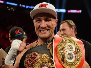 Sergey Kovalev of Russia posses with his belts after defeating Jean Pascal of Laval by way of TKO at the end of the seventh round during the WBO, WBA, and IBF light- heavyweight world championship match at the Bell Centre on January 30, 2016.