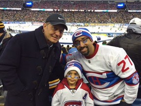 Six-year-old Canadiens fan Syed Adam Ahmed (centre) and his father Sulemaan Ahmed at the NHL Winter Classic on Jan. 1, 2016 with former Boston Bruins player Nevin Markwart.