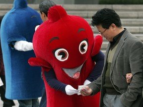 South Koreans dressed in  condom costumes spread awareness at an AIDS awareness campaign on December 1, 2009, in Seoul, South Korea. The event was organized to spread awareness on World AIDS Day.