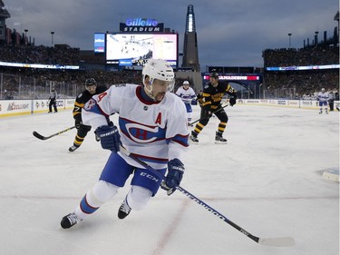 Montreal Canadiens' Tomas Plekanec (14) chases the puck behind Boston Bruins goalie Tuukka Rask (40) during the third period of the NHL Winter Classic hockey game at Gillette Stadium in Foxborough, Mass., Friday, Jan. 1, 2016. The Canadiens won 5-1.