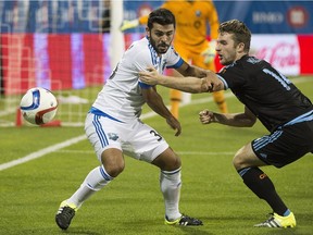 Montreal Impact's Victor Cabrera, left, challenges New York City FC's Patrick Mullins during second half MLS soccer action in Montreal, Saturday, July 4, 2015.