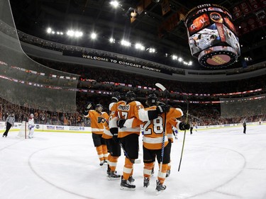 Philadelphia Flyers' Wayne Simmonds, centre, celebrates with Claude Giroux, right, Jakub Voracek, left, and other teammates after scoring a goal during the second period of an NHL hockey game against the Montreal Canadiens, Tuesday, Jan. 5, 2016, in Philadelphia.