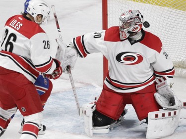 A shot by Max Pacioretty (not in photo) goes in past Cam Ward of the Carolina Hurricanes as John-Michael Liles checks David Desharnais in the second period at the Bell Centre on Sunday, Feb. 7, 2016.