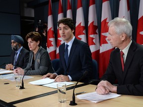 Defence Minister Harjit Sajjan, left to right, International Development Minister Marie-Claude Bibeau, Prime Minister Justin Trudeau and Foreign Affairs Minister Stephane Dion attend a news conference in Ottawa on Monday, Feb. 8, 2016. The Liberal government announced Canada's contribution to the war against the Islamic State of Iraq and the Levant. THE CANADIAN PRESS/Sean Kilpatrick