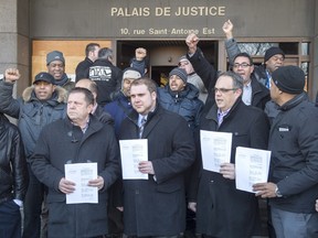 A group representing local taxi drivers react after depositing a request for an injunction against the ride-sharing company Uber at the courthouse Tuesday, Feb. 2, 2016 in Montreal.