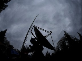 A truck-mounted radar instrument called the Doppler On Wheels is silhouetted against cloudy skies in Washington, Nov. 6, 2015.
