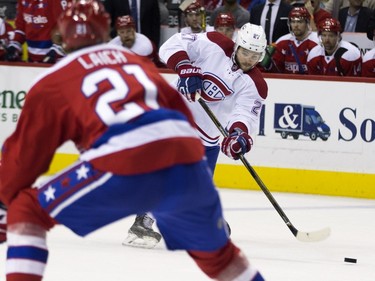 Montreal Canadiens center Alex Galchenyuk, right, shoots the puck as Washington Capitals center Brooks Laich defends during the third period of an NHL hockey game, on Wednesday, Feb. 24, 2016, in Washington. The Canadiens defeated the Capitals 4-3.