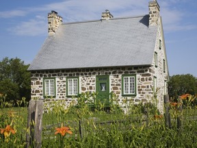 Almost a perfect square measuring 36 x 33 feet, the fieldstone house is small, but it has four levels, as it is built on a slope towards the back. Photo by: Perry Mastrovito