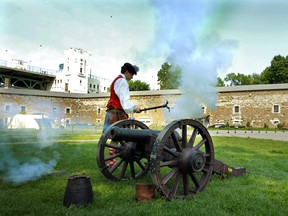 In a 2007 photo, a member of the Olde 78th Regiment known as Fraser's Highlanders  fires a cannon at the Stewart Museum on Île Ste-Hélène.