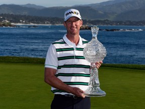 Vaughn Taylor poses with the trophy after winning the AT&T Pebble Beach National Pro-Am at the Pebble Beach Golf Links on February 14, 2016 in Pebble Beach, California.