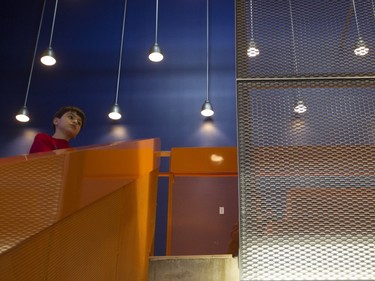 Bastian Farivar takes in a view from a stairwell at the N.D.G. Cultural Centre and Benny Library in Montreal on Saturday, Feb. 6, 2016, at an open house.