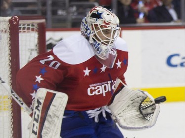 Washington Capitals goalie Braden Holtby, left, makes a save as Montreal Canadiens right wing Dale Weise, right, shoots the puck past Capitals defenseman Brooks Orpik during the first period of an NHL hockey game, on Wednesday, Feb. 24, 2016, in Washington.