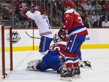 Montreal Canadiens right wing Brendan Gallagher (11) scores past Washington Capitals goalie Braden Holtby (70) during the first period of an NHL hockey game, on Wednesday, Feb. 24, 2016, in Washington. From left, Gallagher, Holtby, Capitals defenseman Matt Niskanen, and Canadiens center Tomas Plekanec.