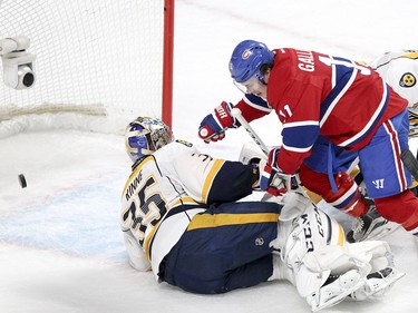 Brendan Gallagher falls over Nashville Predators goalie Pekka Rinne after scoring a goal despite check by defenceman Shea Weber, right, during action on Monday, Feb. 22, at the Bell Centre in Montreal.