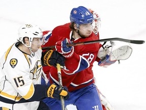 Defenceman Nathan Beaulieu jostles with Nashville Predators' Craig Smith in front of Habs goalie Mike Condon during second-period action on Monday.