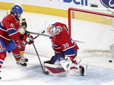 Nashville Predators' Viktor Arvidsson, rear, scores on Mike Condon while being checked by defenceman Mark Barberio during action on Monday, Feb. 22, at the Bell Centre in Montreal.