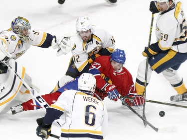 Alex Galchenyuk is surrounded by Nashville Predators, from left, goalie Pekka Rinne, Mike Fisher, Shea Weber and Ryan Johansen after getting a shot on net during first-period action on Monday.