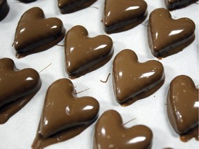 Chocolate covered caramel hearts are laid out after going through the enrober at Daisy's Olde Time Confections Tuesday, Jan. 13, 2015, in Twin Falls, Idaho.