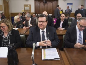 Montreal Mayor Denis Coderre, flanked by Linda Marchand, left, and Aref Salem of the Bureau du Taxi, appears at a legislature committee on the taxi industry, Wednesday, Feb. 24, 2016 at the legislature in Quebec City.