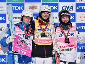 Left to right: Thomas Rowley of the USA (silver), Mikael Kingsbury (gold) of Canada and Benjamin Cavet of France (bronze) pose with their medals during the FIS Freestyle Ski World Cup at Tazawako Ski Resort on February 28, 2016 in Senboku, Japan.