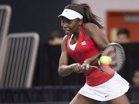 Montreal's Françoise Abanda returns a shot to Belarus' Aliaksandra Sasnovich during the opening match of a Fed Cup tie, Saturday Feb. 6, 2016, in Quebec City.