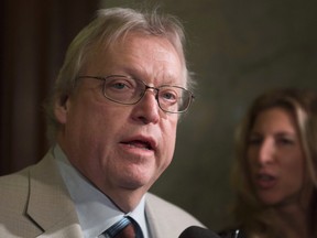 Quebec Health Minister Gaetan Barrette responds to reporters questions on health, at the end of a caucus meeting, Thursday, February 11, 2016 at the legislature in Quebec City.