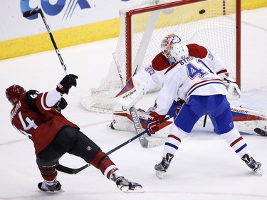Arizona Coyotes' Kevin Connauton sends the puck past Mike Condon and Paul Byron  for a goal during the second period Monday, Feb. 15, 2016, in Glendale, Ariz. (AP Photo/Ross D. Franklin)