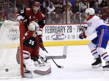 Dale Weise scores on Arizona Coyotes' Louis Domingue as Coyotes' Oliver Ekman-Larsson (23) looks on during the first period of  Monday, Feb. 15, 2016, in Glendale, Ariz.