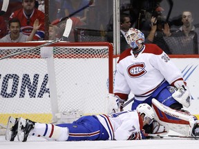 Mike Condon and Alexei Emelin react to giving up a goal to Arizona Coyotes' Anthony Duclair during the first period Monday.