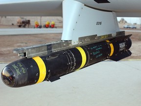 An AGM-114 Hellfire missile hung on the rail of an US Air Force (USAF) MQ-1L Predator Unmanned Aerial Vehicle (UAV).