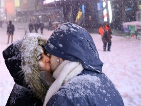 Leticia Pereira, 20, and Luiz Veiga, 23, kiss in Times Square Jan. 23, 2016 in New York City.