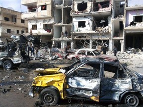 In this photo released by the Syrian official news agency SANA, Syrian citizens gather at the scene where two blasts exploded in the pro-government neighbourhood of Zahraa, in Homs province, Syria, Sunday, Feb. 21, 2016.