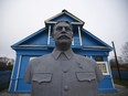In this Wednesday, Dec. 9, 2015 photo a bust of Soviet leader Josef Stalin stands on the front lawn of a house-turned-museum in the village of Khoroshevo, west of Moscow, Russia. The Stalin museum was opened this year in this small village where the Soviet leader is said to have stayed the night on his only visit to the front during World War II.