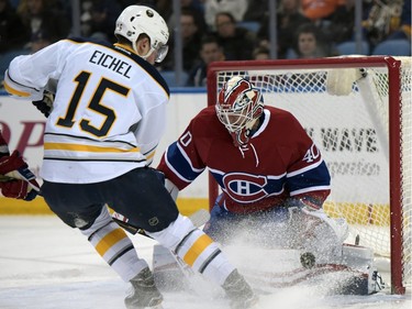 Buffalo Sabres centrer Jack Eichel (15) redirects a shot on Montreal Canadiens goaltender Ben Scrivens (40) during the first period of an NHL hockey game Friday, Feb. 12, 2016 in Buffalo, N.Y.