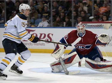 Buffalo Sabres centre Jack Eichel (15) chases a high shot as Montreal Canadiens goaltender Mike Condon (39) watches the puck during the third period of an NHL hockey game, Friday, Feb. 12, 2016 in Buffalo, N.Y.  Buffalo won 6-4.