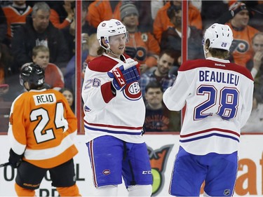 Montreal Canadiens' Jeff Petry (26) and Nathan Beaulieu (28) celebrate after Petry's goal during the second period of an NHL hockey game against the Philadelphia Flyers, Tuesday, Feb. 2, 2016, in Philadelphia.