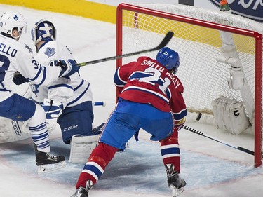 Montreal Canadiens' Devante Smith-Pelly (21) scores on Toronto Maple Leafs goaltender Jonathan Bernier as Leafs' Mark Arcobello (33) defends during second period NHL hockey action in Montreal, Saturday, February 27, 2016.