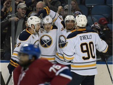 Buffalo Sabres' Josh Gorges (4), Marcus Foligno (82), Evander Kane (9) and Ryan O'Reilly (90) celebrate a goal by Kane as Montreal Canadiens' P.K. Subban (76) reacts during the first period of an NHL hockey game, Friday, Feb. 12, 2016 in Buffalo, N.Y.