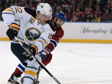 Buffalo Sabres' Marcus Foligno (82) moves around Montreal Canadiens' Andrei Markov, right, during the first period of an NHL hockey game, Friday, Feb. 12, 2016, in Buffalo, N.Y.
