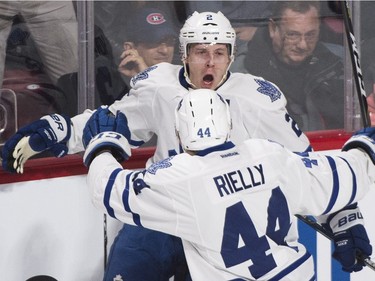 Toronto Maple Leafs' Matt Hunwick (2) celebrates with teammate Morgan Rielly (44) after scoring against the Montreal Canadiens during first period NHL hockey action in Montreal, Saturday, February 27, 2016.