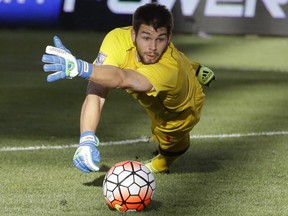 Canada goalkeeper Maxime Crepeau dives for the ball during the second half of a CONCACAF men's Olympic semifinal soccer match against Mexico, Saturday, Oct. 10, 2015, in Sandy, Utah. Canada's national team thinks highly enough of goalkeeper Maxime Crepeau to make him a starter, but he remains the third string goalie on the Montreal Impact behind veterans Evan Bush and Eric Kronberg, patiently awaiting his chance to move up the depth chart.