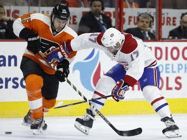 Philadelphia Flyers' Michael Del Zotto, left, and Montreal Canadiens' Torrey Mitchell battle for the puck during the first period of an NHL hockey game, Tuesday, Feb. 2, 2016, in Philadelphia.