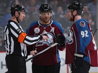 Captain Gabriel Landeskog #92 of the Colorado Avalanche protests a call by referee Steve Kozari #40 on a penalty against Jarome Iginla #12 of the Colorado Avalanche against the Montreal Canadiens in the second period at Pepsi Center on February 17, 2016 in Denver, Colorado.