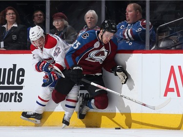 Sven Andrighetto #42 of the Montreal Canadiens puts a hit on Mikhail Grigorenko #25 of the Colorado Avalanche as they pursue the puck at Pepsi Center on February 17, 2016 in Denver, Colorado.