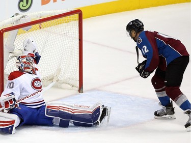 Jarome Iginla #12 of the Colorado Avalanche puts the puck past goalie Ben Scrivens #40 of the Montreal Canadiens to score the game-winning goal in the third period at Pepsi Center on February 17, 2016 in Denver, Colorado. The Avalanche defeated the Canadiens 3-2.