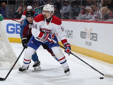 Tomas Plekanec #14 of the Montreal Canadiens controls the puck against Nick Holden #2 of the Colorado Avalanche at Pepsi Center on February 17, 2016 in Denver, Colorado.