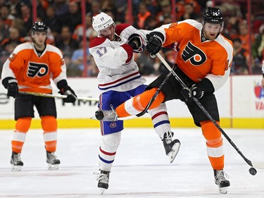 Sean Couturier #14 of the Philadelphia Flyers is checked by Torrey Mitchell #17 of the Montreal Canadiens during the second period at Wells Fargo Center on February 2, 2016 in Philadelphia, Pennsylvania.