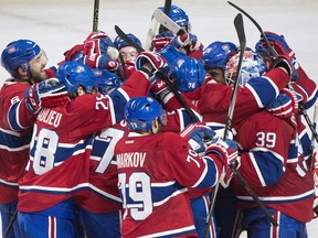 Players from the Montreal Canadiens celebrate after defeating the Philadelphia Fyers in a NHL shootout in Montreal, Friday, February 19, 2016.