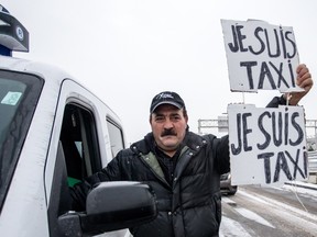 Montreal taxi driver Abdel Ghani participates in protest against Uber at Trudeau airport on Wednesday, February 10, 2016